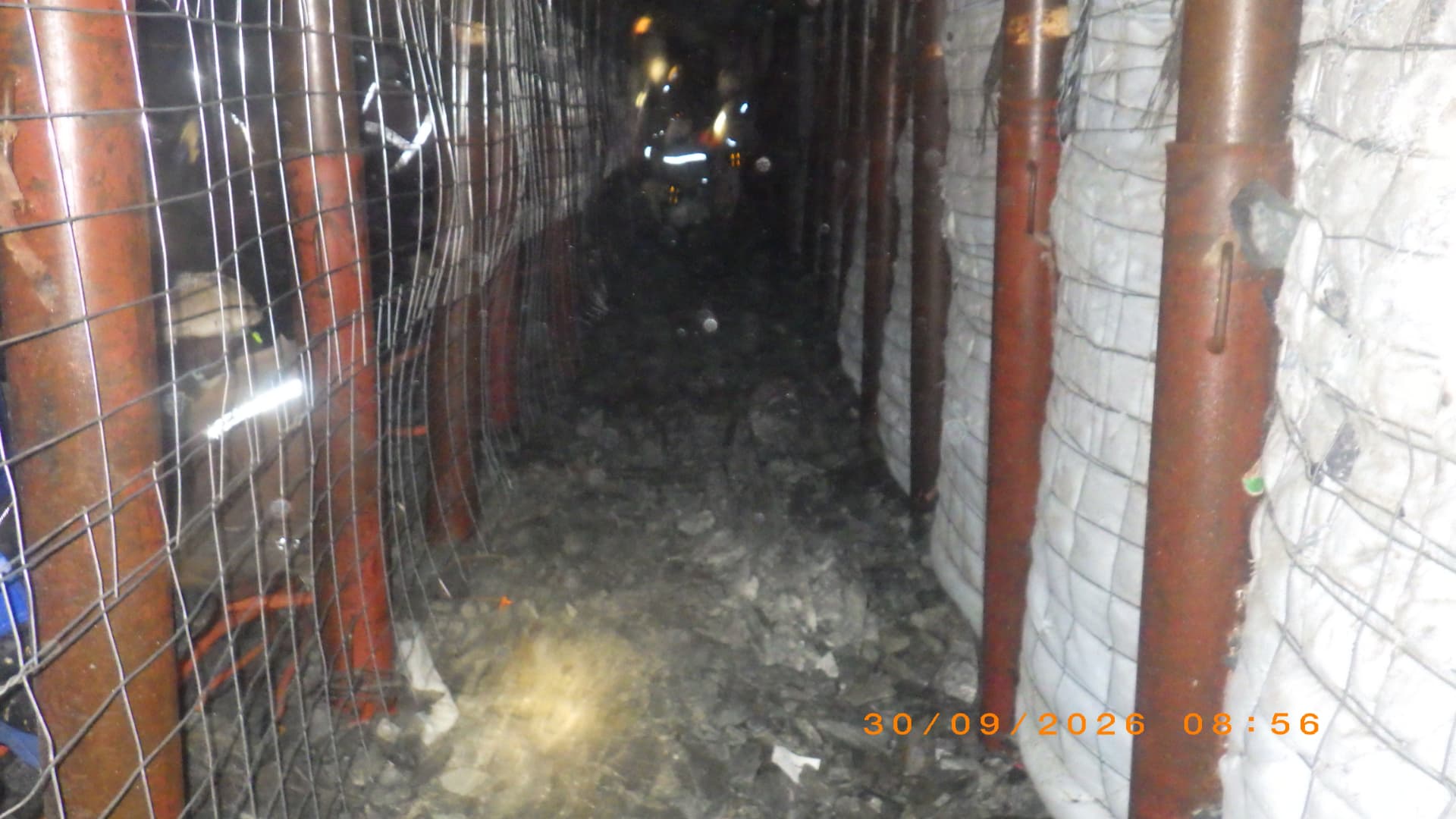 Backfill Contracting: Backfill line in the stope. Completed backfill line running along the stope with crew on site.