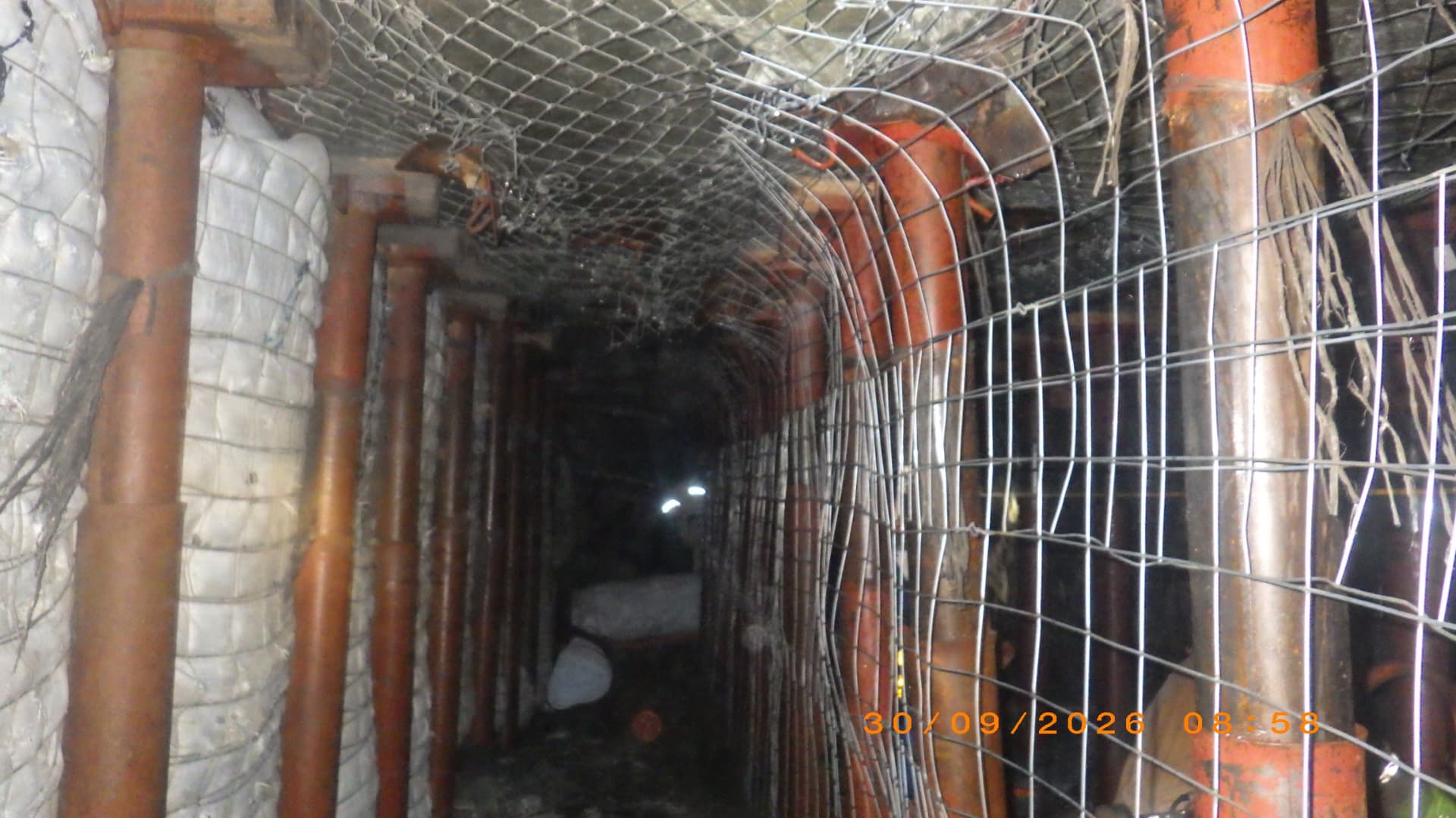 Backfill Contracting: Mesh-contained backfill line. Backfill line contained by mesh along the hanging wall to hold fill in place.
