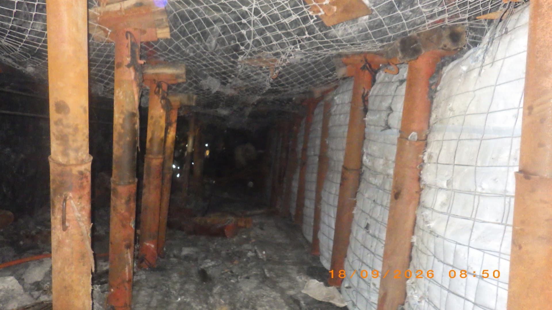 Backfill Contracting: Bags placed between props. Filled backfill bags placed between support props to support the hanging wall.